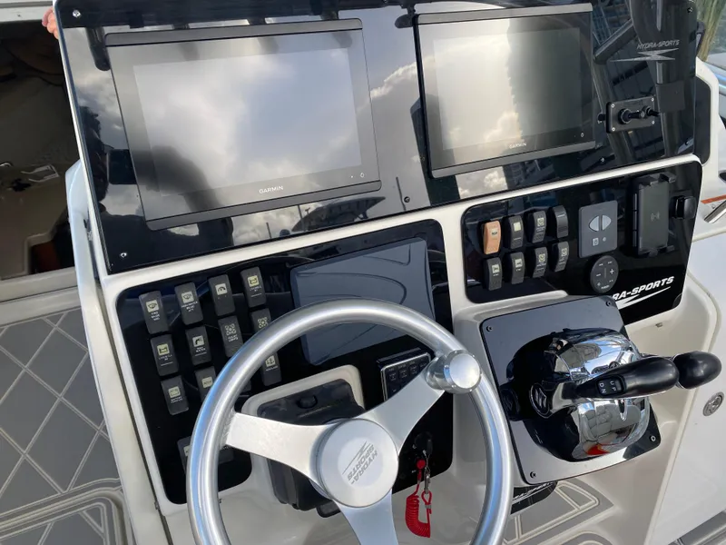 Slide: The Image of 2006 Hydra-Sports Vector 3300 VX dashboard with Garmin displays and steering wheel. - 23