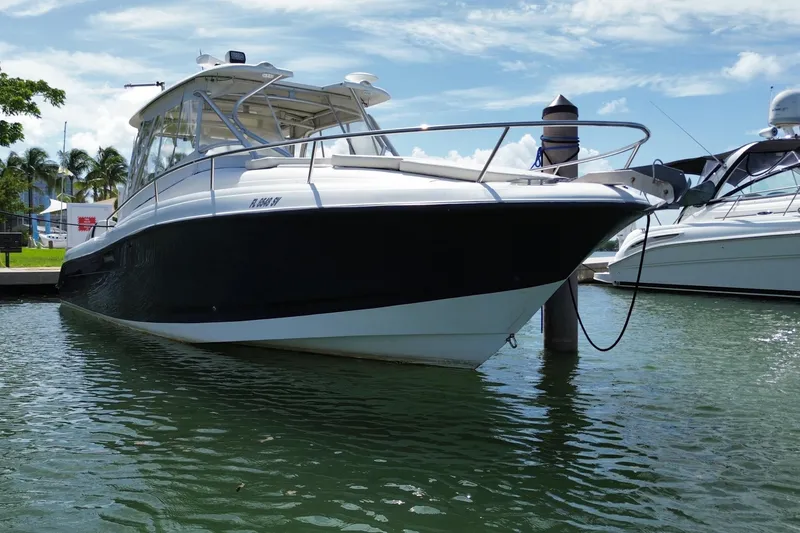 Slide: The Image of 2006 Hydra-Sports Vector 3300 VX boat docked in a marina under a clear blue sky. - 12
