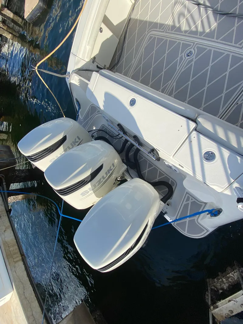 Slide: The Image of 2006 Hydra-Sports Vector 3300 VX with triple Suzuki outboard motors docked. - 25