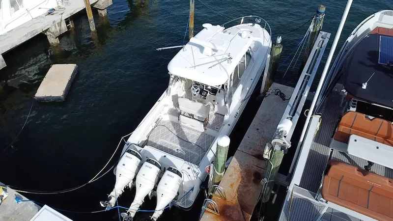 Slide: The Image of 2006 Hydra-Sports Vector 3300 VX boat docked with triple outboard engines. - 26