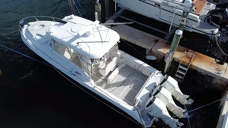 Slide: The Image of 2006 Hydra-Sports Vector 3300 VX boat docked with twin outboard engines. - 28