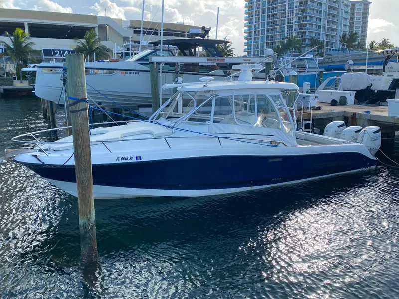 Slide: The Image of 2006 Hydra-Sports Vector 3300 VX boat docked at marina, surrounded by other vessels. - 3