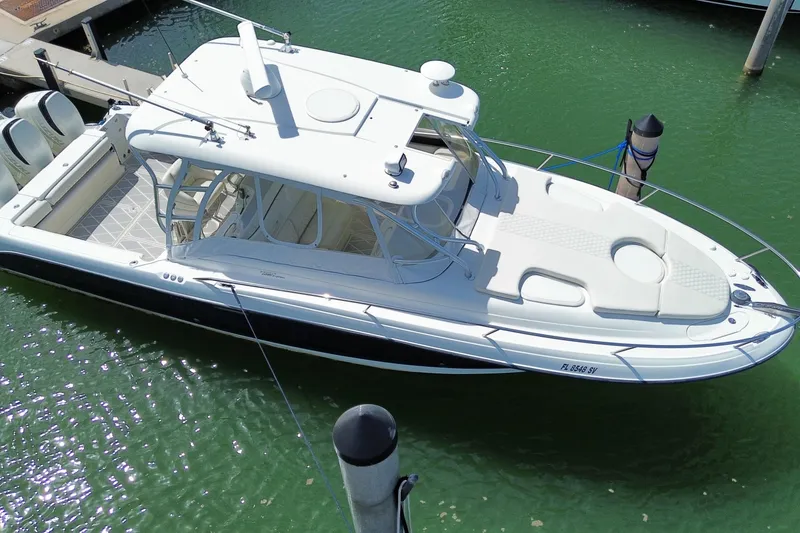 Slide: The Image of 2006 Hydra-Sports Vector 3300 VX boat docked in clear green water. - 11