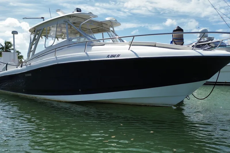Slide: The Image of 2006 Hydra-Sports Vector 3300 VX boat docked on calm water under a clear sky. - 9