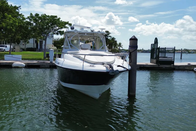Slide: The Image of 2006 Hydra-Sports Vector 3300 VX boat docked in a serene marina setting. - 5