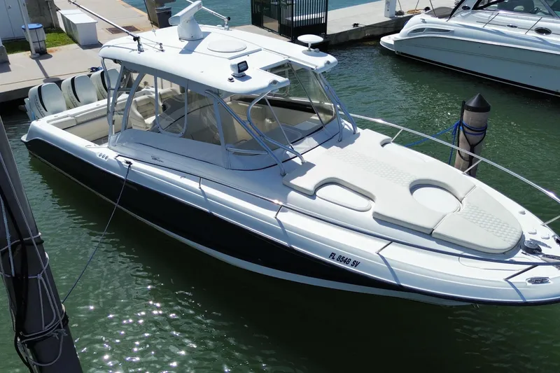 Slide: The Image of 2006 Hydra-Sports Vector 3300 VX boat docked in marina, featuring sleek design and spacious deck. - 7