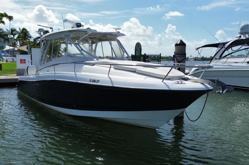 Slide: The Image of 2006 Hydra-Sports Vector 3300 VX boat docked in a marina under a clear sky. - 2