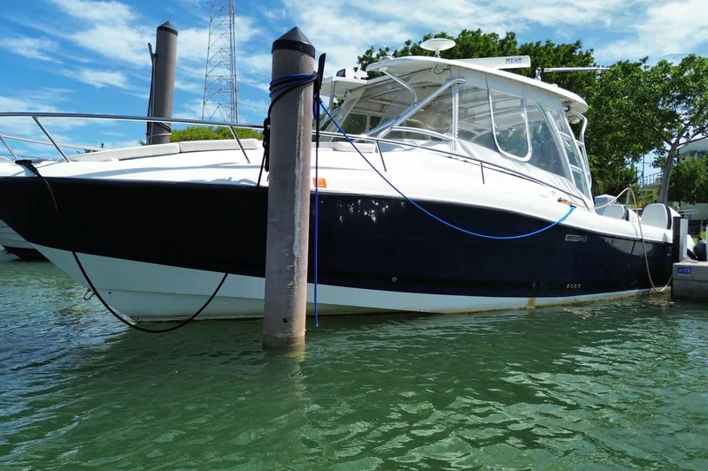 Slide: The Image of 2006 Hydra-Sports Vector 3300 VX boat docked in marina, clear sky background. - 10
