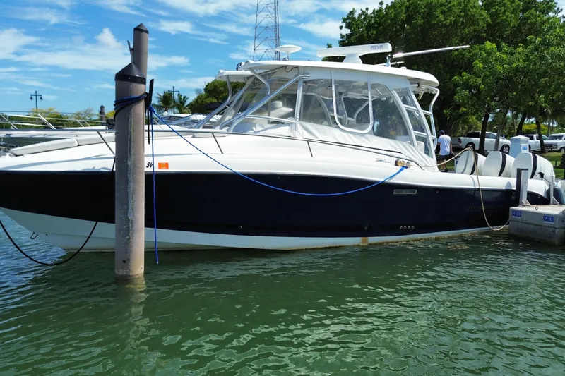 Slide: The Image of 2006 Hydra-Sports Vector 3300 VX boat docked in a marina under a clear blue sky. - 3
