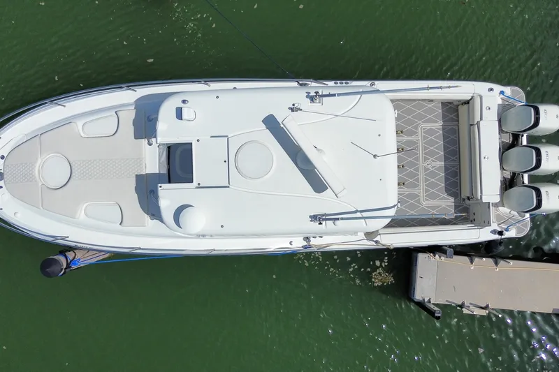 Slide: The Image of Aerial view of 2006 Hydra-Sports Vector 3300 VX boat docked on green water. - 32
