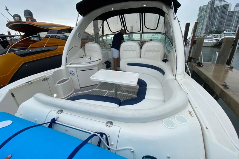 Slide: The Image of 2004 Sea Ray 340 Sundancer boat interior with seating and table at marina. - 14