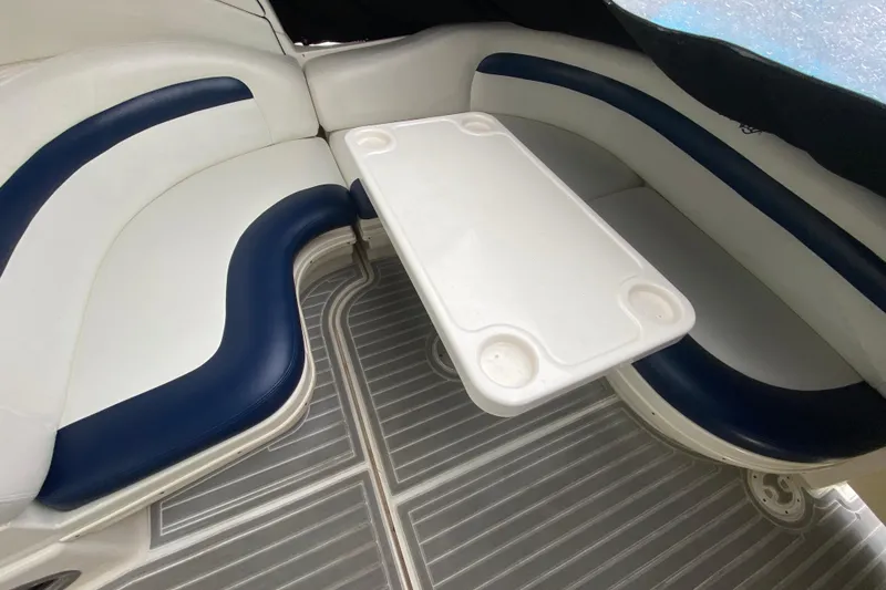 Slide: The Image of 2004 Sea Ray 340 Sundancer interior with white and blue seating, table, and striped flooring. - 16