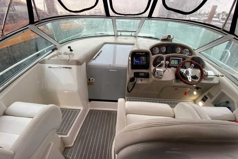 Slide: The Image of 2004 Sea Ray 340 Sundancer cockpit with modern controls and comfortable seating. - 18