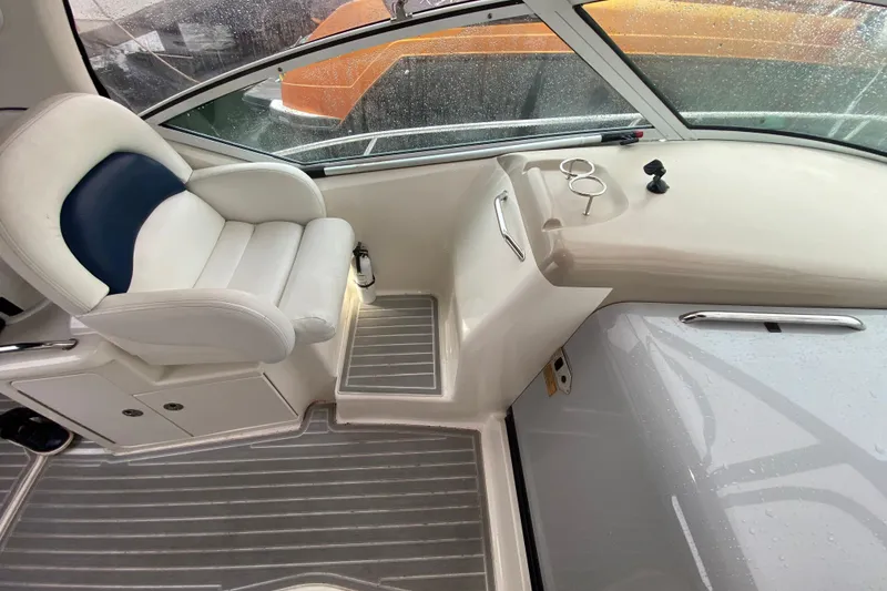 Slide: The Image of 2004 Sea Ray 340 Sundancer cockpit with white seating and sleek dashboard design. - 19
