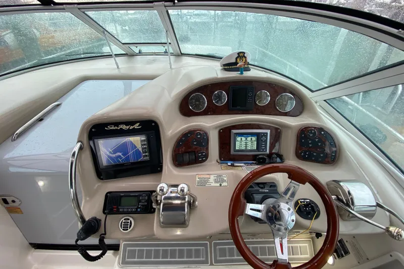 Slide: The Image of 2004 Sea Ray 340 Sundancer helm with navigation equipment and steering wheel. - 22