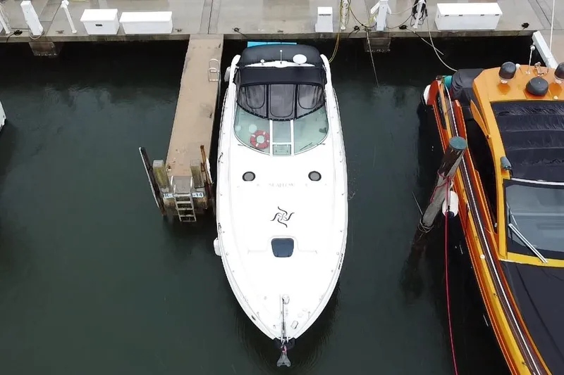 Slide: The Image of Aerial view of a 2004 Sea Ray 340 Sundancer docked at a marina. - 6