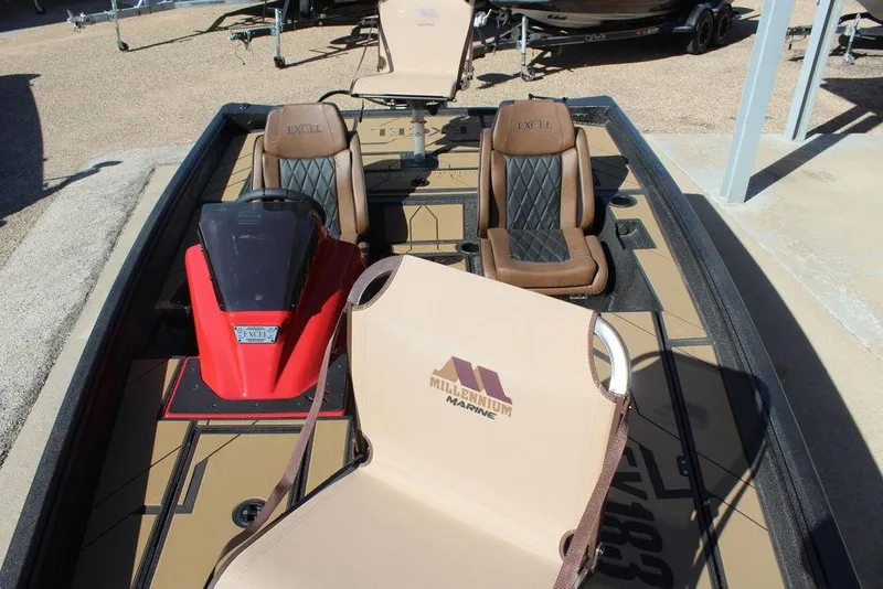 Slide: The Image of 2026 Excel EX 183 boat interior with brown seats and red console. - 12