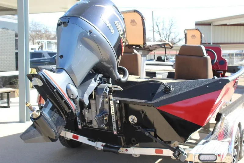 Slide: The Image of 2026 Excel EX 183 boat with powerful outboard motor, red and black design, on trailer. - 5