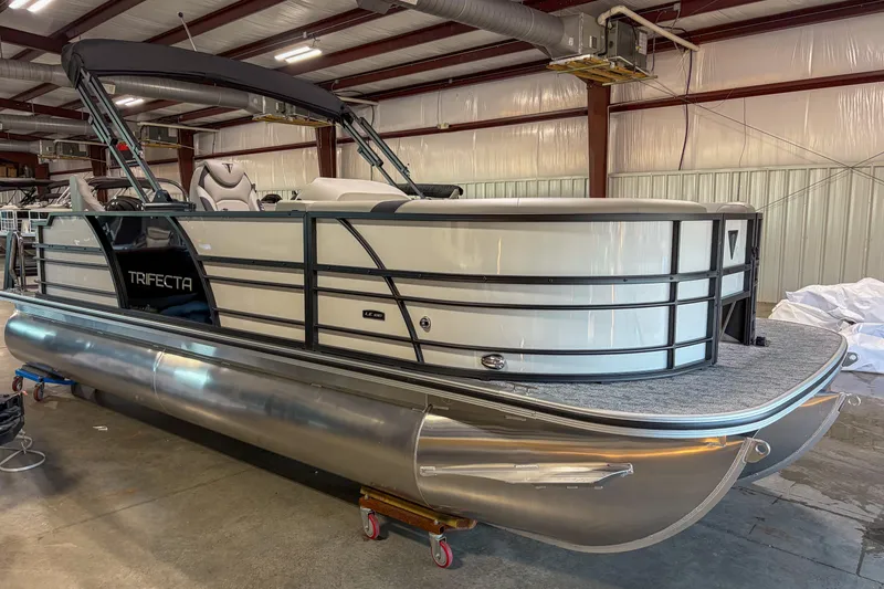 Slide: The Image of 2026 Trifecta 22 TRFC LE pontoon boat in a warehouse setting. - 3