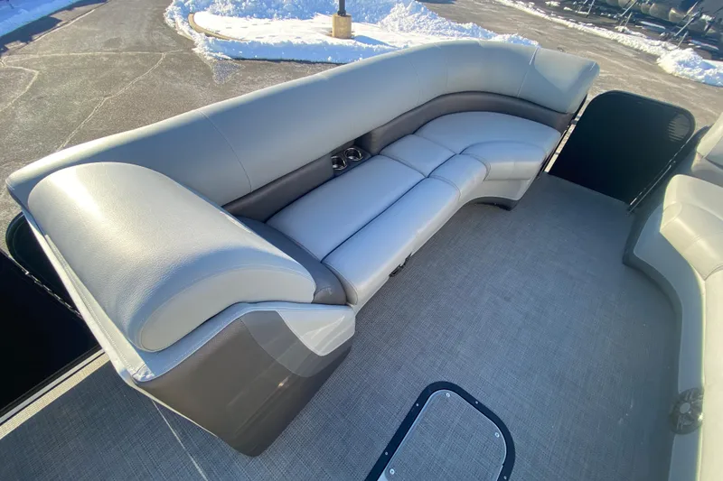 Slide: The Image of 2022 Manitou 25 OASIS RF SHP boat interior with gray seating and carpet. - 11