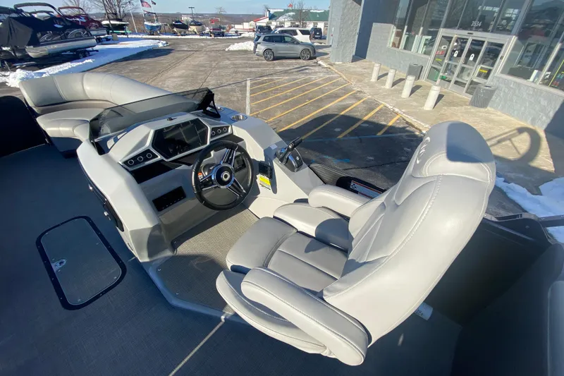 Slide: The Image of 2022 Manitou 25 OASIS RF SHP boat interior with modern helm and seating. - 15