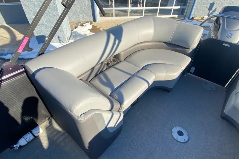 Slide: The Image of 2022 Manitou 25 OASIS RF SHP boat interior with gray seating and cup holders. - 21