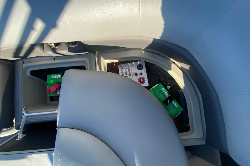 Slide: The Image of 2022 Manitou 25 OASIS RF SHP boat interior storage compartment with battery switch. - 23