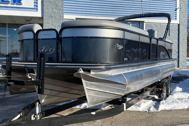 Slide: The Image of 2022 Manitou 25 OASIS RF SHP pontoon boat on trailer outside dealership. - 3