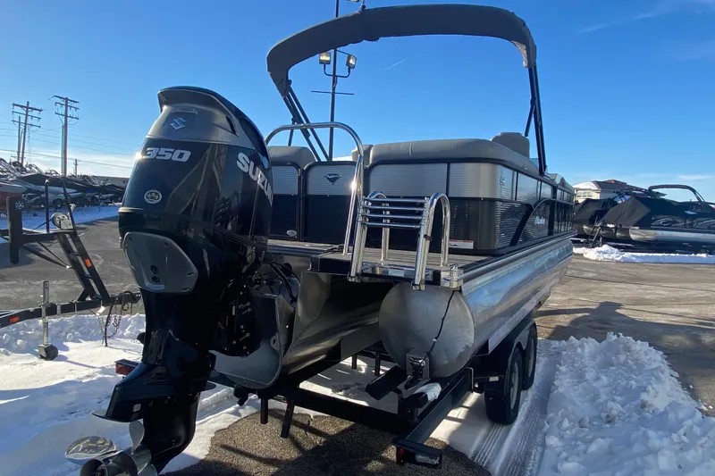 Slide: The Image of 2022 Manitou 25 OASIS RF SHP pontoon boat with Suzuki 350 engine in snowy setting. - 5