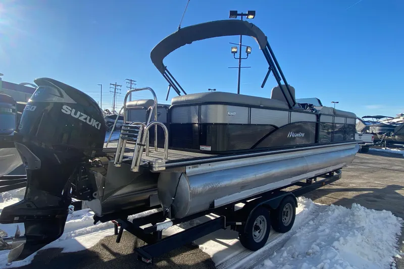 Slide: The Image of 2022 Manitou 25 OASIS RF SHP pontoon boat with Suzuki engine on trailer. - 6