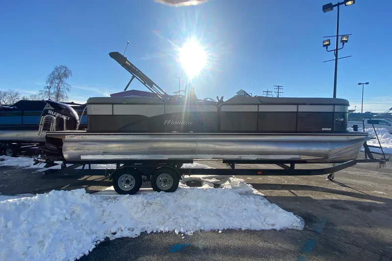 Slide: The Image of 2022 Manitou 25 OASIS RF SHP pontoon boat on trailer, sunny winter day. - 7