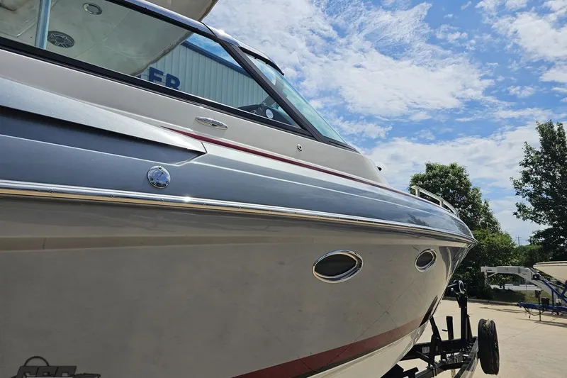 Slide: The Image of 2020 Formula 330 Crossover Bowrider boat on trailer under blue sky. - 10
