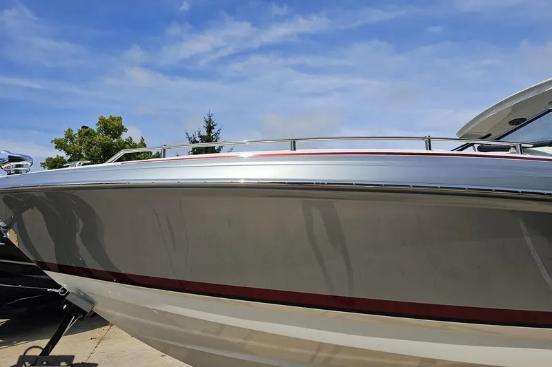 Slide: The Image of 2020 Formula 330 Crossover Bowrider boat under clear blue sky. - 18