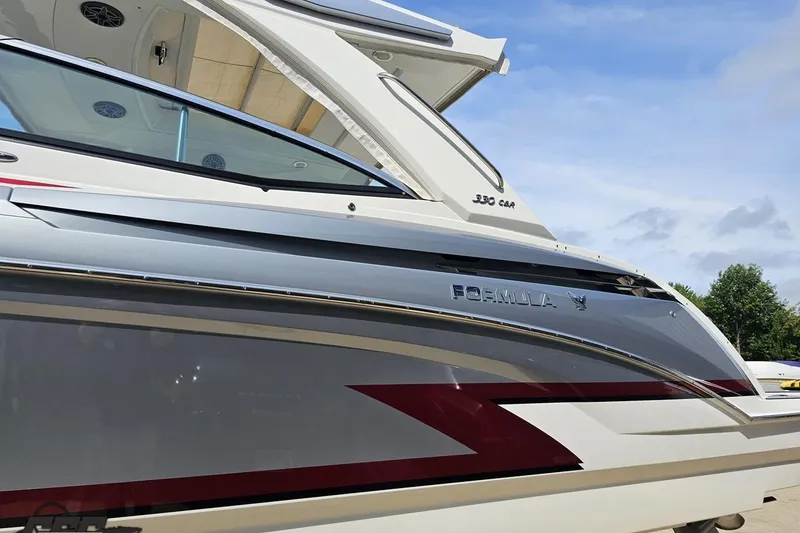 Slide: The Image of 2020 Formula 330 Crossover Bowrider boat, sleek design, side view, outdoors. - 22