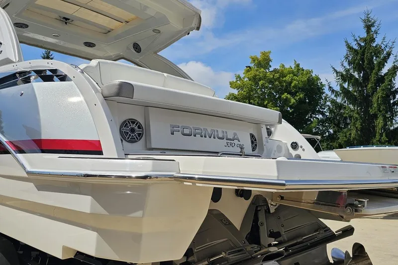 Slide: The Image of 2020 Formula 330 Crossover Bowrider boat, rear view with sleek design and branding. - 28