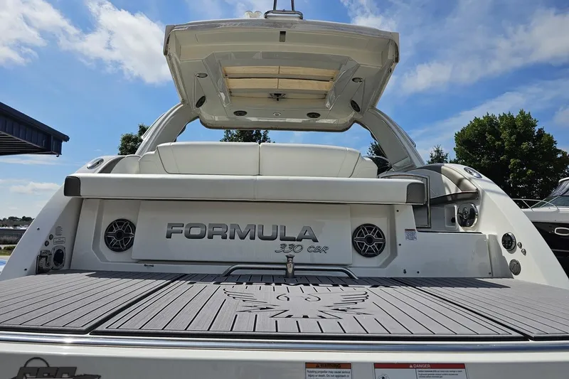 Slide: The Image of 2020 Formula 330 Crossover Bowrider boat, rear view with seating and speakers. - 33