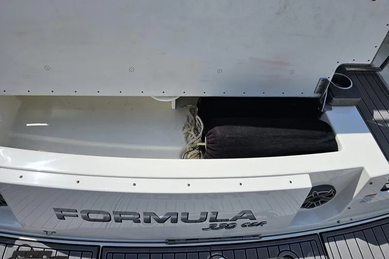 Slide: The Image of 2020 Formula 330 Crossover Bowrider storage compartment with rope and cushion. - 38