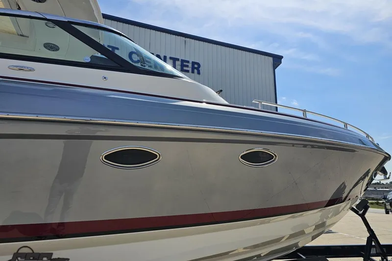 Slide: The Image of 2020 Formula 330 Crossover Bowrider boat at a marina, side view. - 5