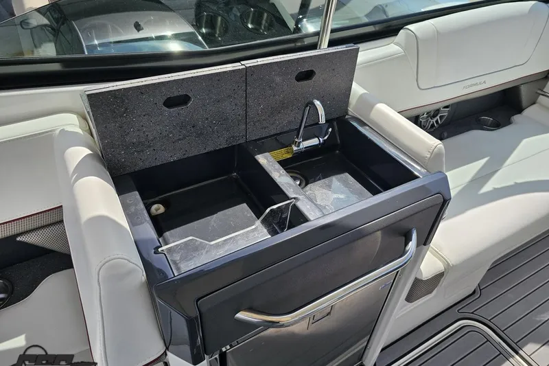 Slide: The Image of 2020 Formula 330 Crossover Bowrider interior with sink and seating area. - 56