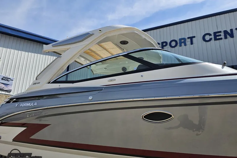 Slide: The Image of 2020 Formula 330 Crossover Bowrider boat at a marine center, side view. - 6