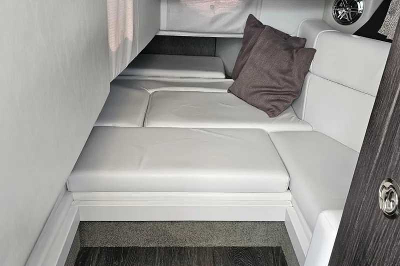 Slide: The Image of 2020 Formula 330 Crossover Bowrider cabin interior with cushioned seating and pillows. - 72
