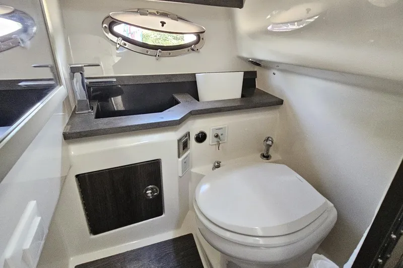 Slide: The Image of 2020 Formula 330 Crossover Bowrider bathroom with modern fixtures and porthole window. - 79