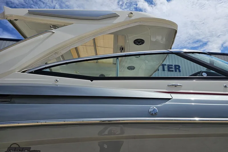 Slide: The Image of 2020 Formula 330 Crossover Bowrider boat, sleek design under a blue sky. - 8