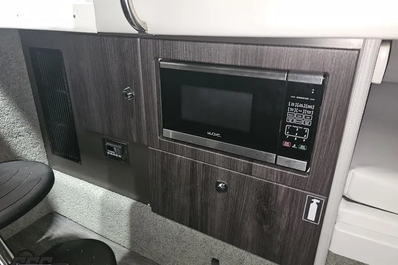 Slide: The Image of 2020 Formula 330 Crossover Bowrider interior with built-in microwave and modern cabinetry. - 81