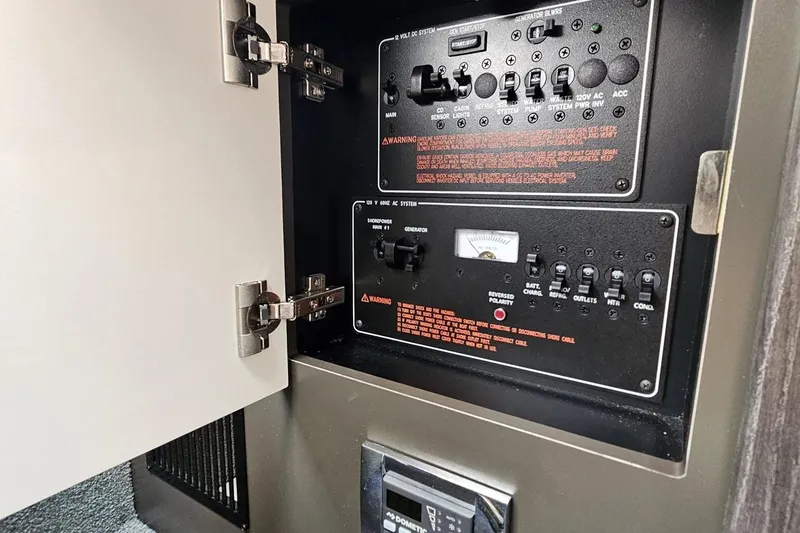 Slide: The Image of Control panel inside 2020 Formula 330 Crossover Bowrider boat, featuring switches and gauges. - 82