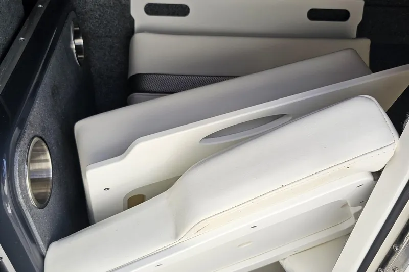 Slide: The Image of 2020 Formula 330 Crossover Bowrider interior storage with white cushioned seats. - 88