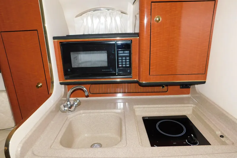 Slide: The Image of 2001 Sea Ray Sundancer 280 galley with microwave, sink, and stovetop. - 19