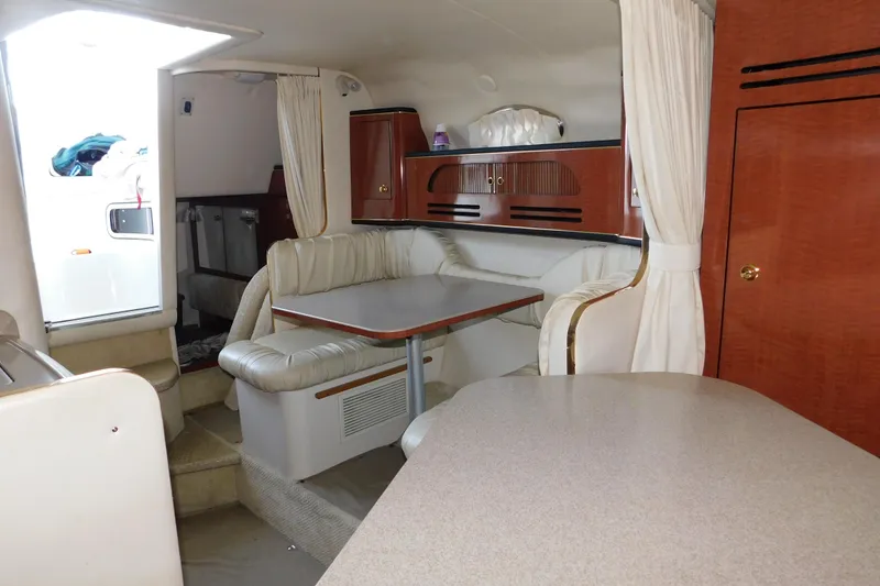 Slide: The Image of Interior of 2001 Sea Ray Sundancer 280, featuring a cozy dining area with wood accents. - 21
