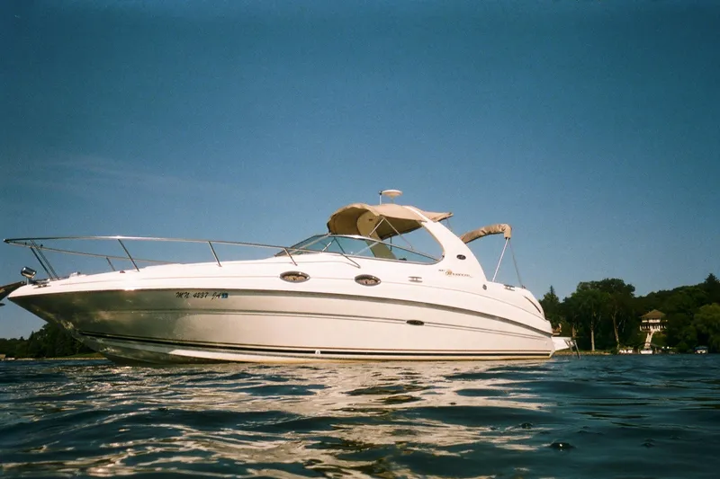 Slide: The Image of 2001 Sea Ray Sundancer 280 boat on calm water under clear blue sky. - 5