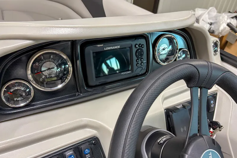 Slide: The Image of Dashboard of 2026 Trifecta 24RF LE with gauges and Lowrance display. - 10